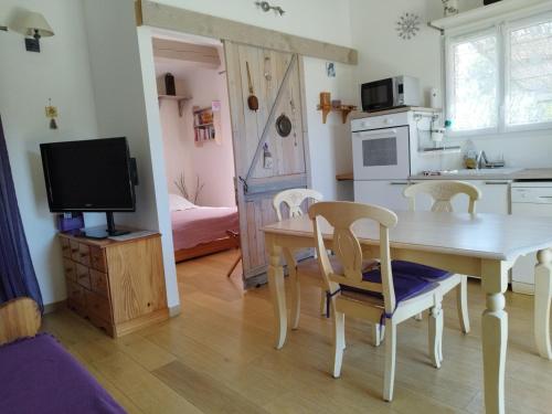 a kitchen and dining room with a table and chairs at Gite Bardelle in Orgnac-lʼAven