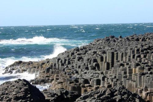 a large rock formation on the shore of the ocean at 3 Bedroom Penthouse Apartment in larne in Larne