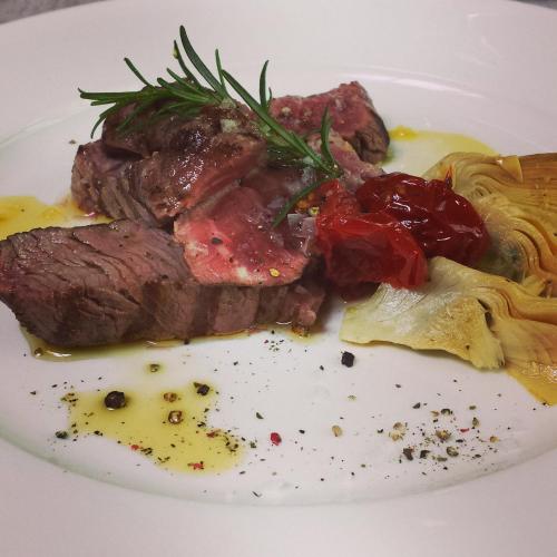 a plate of food with meat and spaghetti on it at Grand Hotel Tiziano E Dei Congressi in Lecce
