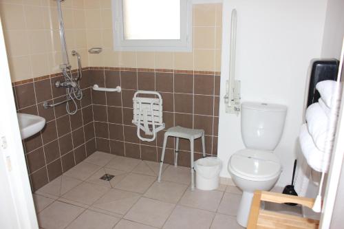 a bathroom with a shower with a toilet and a sink at The Originals City, Hôtel Côté Sud, Marseille Est in Allauch