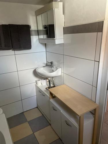 a small bathroom with a sink and a mirror at Monteurzimmer für 2 Person - Nähe DO-Flughafen in Dortmund