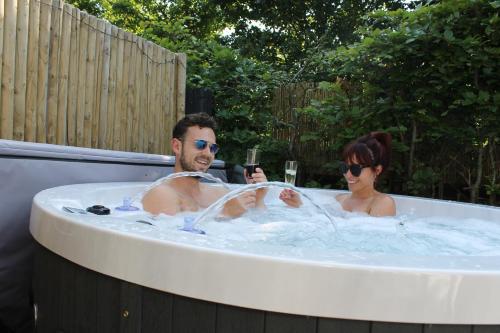 a man and a woman sitting in a bath tub at Studio ter Duyn in Ouddorp