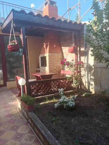 a backyard with a brick oven and a patio at Villa Mars in Sunny Beach