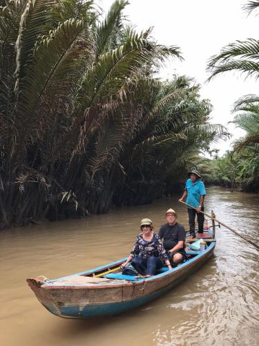 a group of people on a boat in the water at Nguyet Que Homestay & Tours in Ben Tre