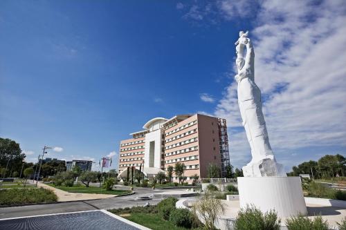 a large statue in front of a building at Hotel Rafael in Milan