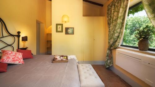 a bedroom with a bed and a large window at CASALE DELL'OASI 12, Emma Villas in Gallese