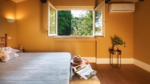 a bedroom with a bed and a window at CASALE DELL'OASI 12, Emma Villas in Gallese