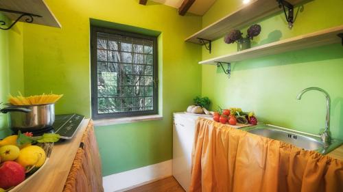 a kitchen with a counter with fruits and vegetables on it at CASALE DELL'OASI 12, Emma Villas in Gallese