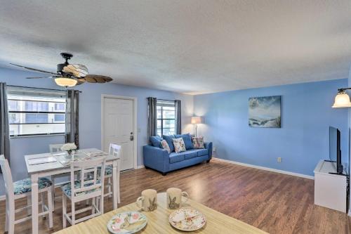 a living room with a table and a blue wall at Idyllic Fort Pierce Retreat - Walk to Beach! in Fort Pierce