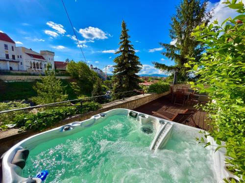a jacuzzi tub with green water in a yard at Terrace Apartman Prémium Belváros Jacuzzival in Veszprém