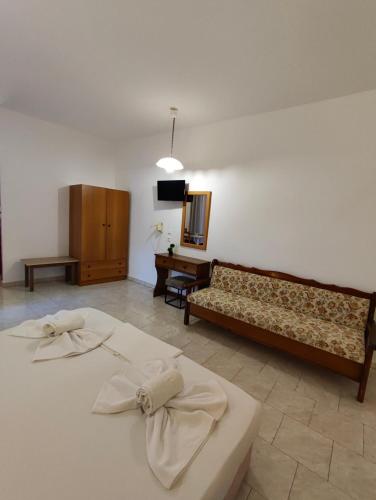 a living room with two beds and a couch at Sea Harmony in Kalathos
