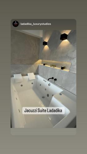 a white bath tub sitting in a room at Jacuzzi Suite Ladadika in Thessaloniki