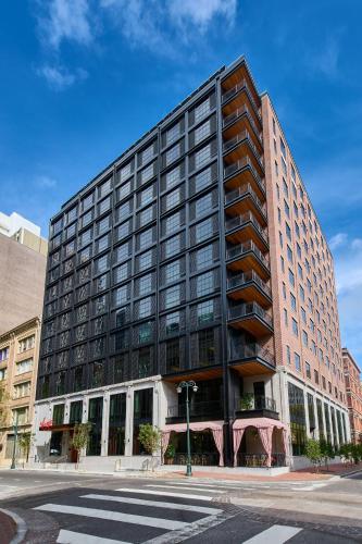 a large building on a city street with a crosswalk at Virgin Hotels New Orleans in New Orleans