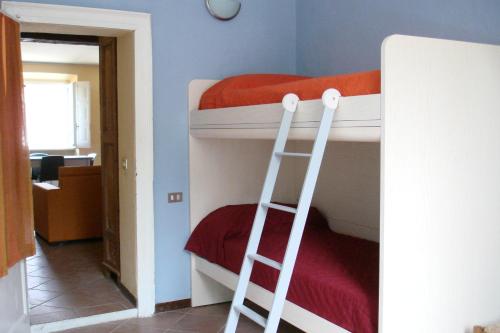a room with two bunk beds with a ladder at Apartments Cabianchi in Orta San Giulio
