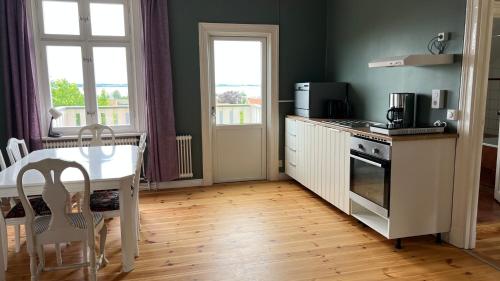 a kitchen with a table and a stove top oven at Sjögatan 21, in Gränna