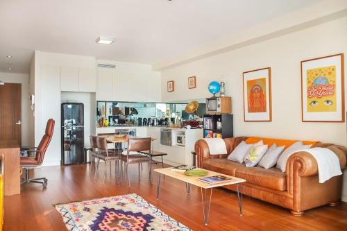 a living room with a couch and a table at Sprawling Modern City Pad Opposite Enmore Theatre in Sydney