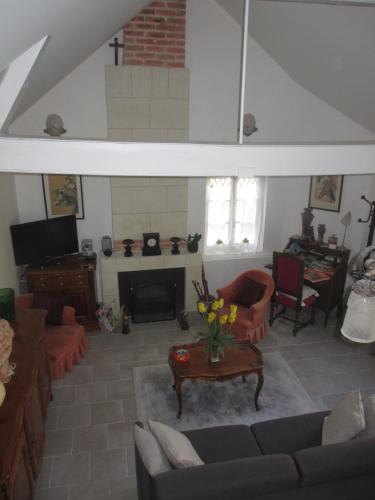 a living room with a couch and a fireplace at Le Pavillon Tilia in Montrichard
