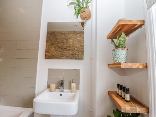 a bathroom with a sink and a mirror at Old Rectory Cottage in Lincoln