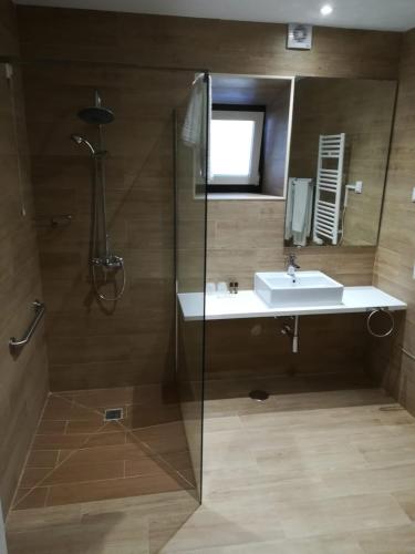 a bathroom with a sink and a shower at Alojamento Local Boega Hotel - Casas Boega I e II in Gondarém