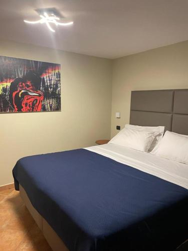 a bedroom with a large bed and a painting on the wall at Residence l'Incanto in Piano di Sorrento