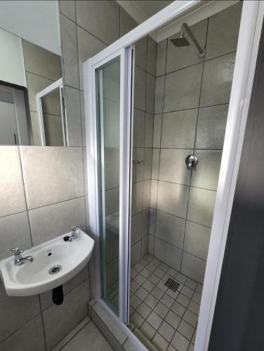 a bathroom with a shower and a sink at Grace Villas 8 in East London