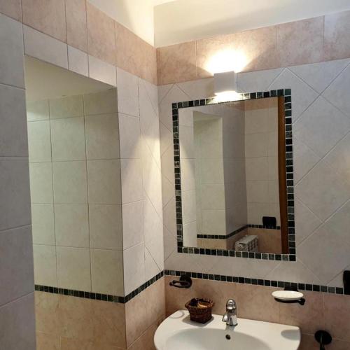 a bathroom with a sink and a mirror at Residence l'Incanto in Piano di Sorrento