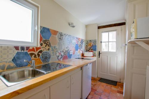 a kitchen with a sink and a window at La Bohal' Loire in La Bohalle