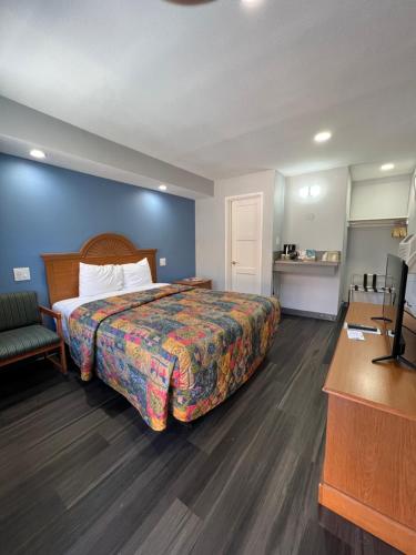 Habitación de hotel con cama y TV en Bishop Elms Motel en Bishop