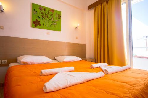 a bedroom with two beds with towels on them at Sea Harmony in Kalathos