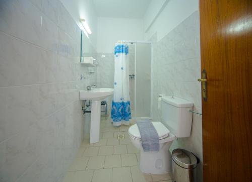 a bathroom with a toilet and a sink at Sea Harmony in Kalathos