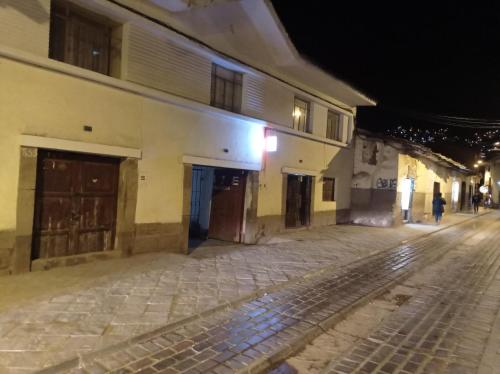 an empty street in an old town at night at CHINA SAQRA in Cusco
