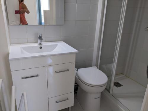 een badkamer met een toilet, een wastafel en een douche bij Fouras - T2 Hyper centre les pieds dans le sable ! in Fouras