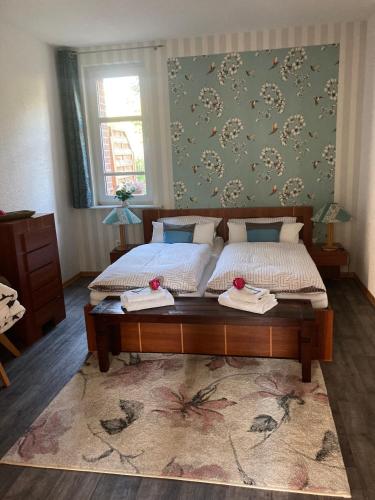 a bedroom with two beds with towels on them at Villa Irene am Inselsee in Mühl Rosin