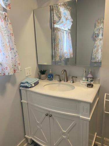 a bathroom with a sink and a mirror at First floor, 2 bedrm 2 bath, sleeps 6, Parking available, walk to Beach & Shop in Cape May