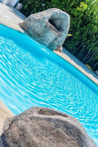 a pool of water with some rocks in it at Sisula Country Hotel & SPA in Orosei