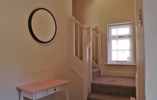a staircase with a mirror on the wall and a stair case at Meadow Terrace in Shrewsbury