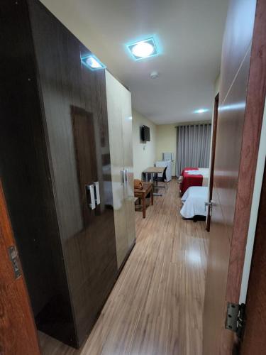 a hotel room with a bed and a sliding door at Pousada Coqueiral in Aracruz
