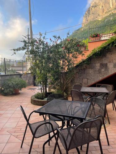 a group of tables and chairs on a patio at Residence l'Incanto in Piano di Sorrento