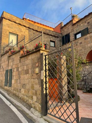 a brick building with a gate in front of it at Residence l'Incanto in Piano di Sorrento