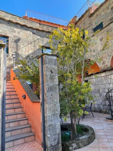 a staircase with a tree next to a building at Residence l'Incanto in Piano di Sorrento