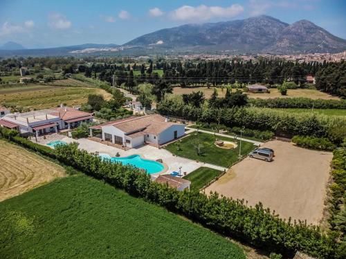 an aerial view of a estate with a pool and a house at Sisula Country Hotel & SPA in Orosei