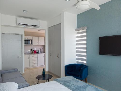 a bedroom with a bed and a blue wall at Tramonto Resort Mazatlan in Mazatlán