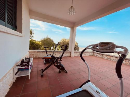 a house with two exercise bikes on a patio at Domus Valentina in Selva di Fasano