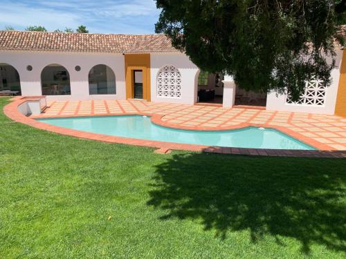 a swimming pool in the yard of a house at Casa Pitta Charm Villa in Santarém