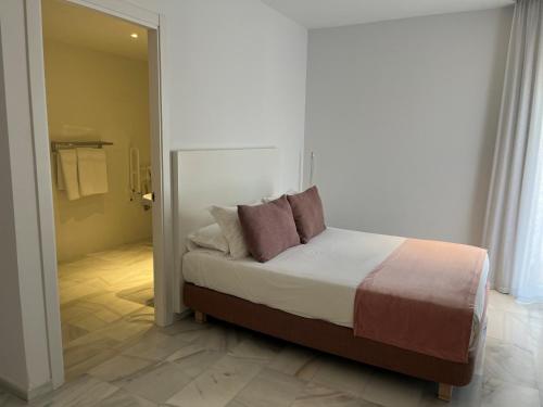Hotel Aromarにあるベッド
