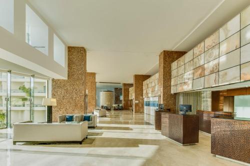 a lobby of a building with couches and tables at Live Aqua Cancun - Adults Only - All-Inclusive in Cancún