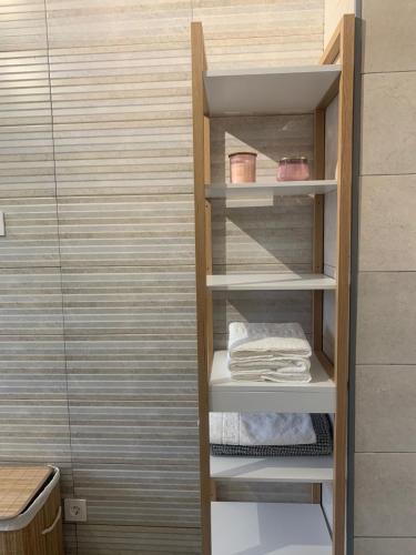 a walk in closet with white shelves and towels at El Balcón de la Roca in Setenil