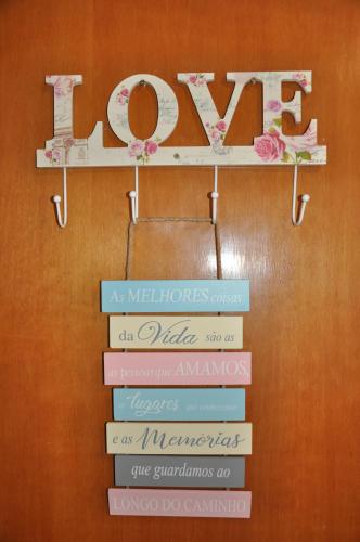 a sign that says love with different colored books at Pousada Suites Bougainville in Cavalcante