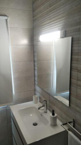 a bathroom with a sink and a mirror at El Balcón de la Roca in Setenil