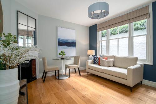 a living room with a couch and a table at 5 Doughty Street - Urban Apartments in London